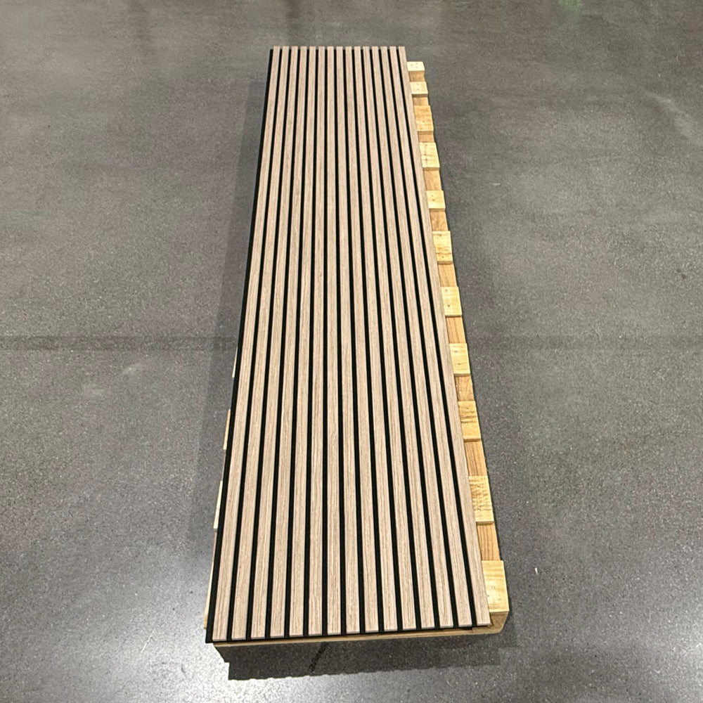 Light wood-look slatted panel displayed on a workshop floor